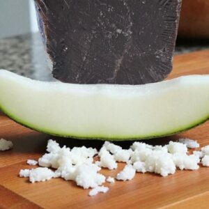 A slice of honeydew and coconut shaving representing the great smell of our cold process soap